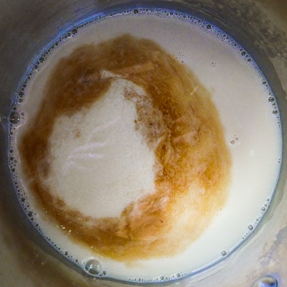 vegan custard being cooked in a sauce pan.