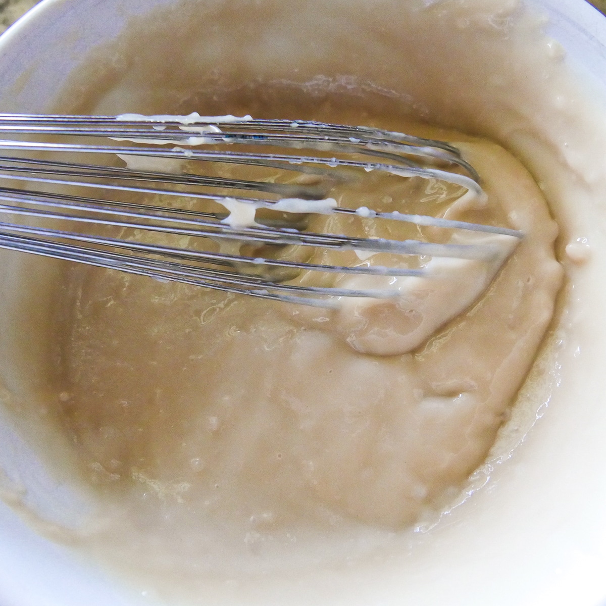 vegan pastry cream being whisked in a bowl.