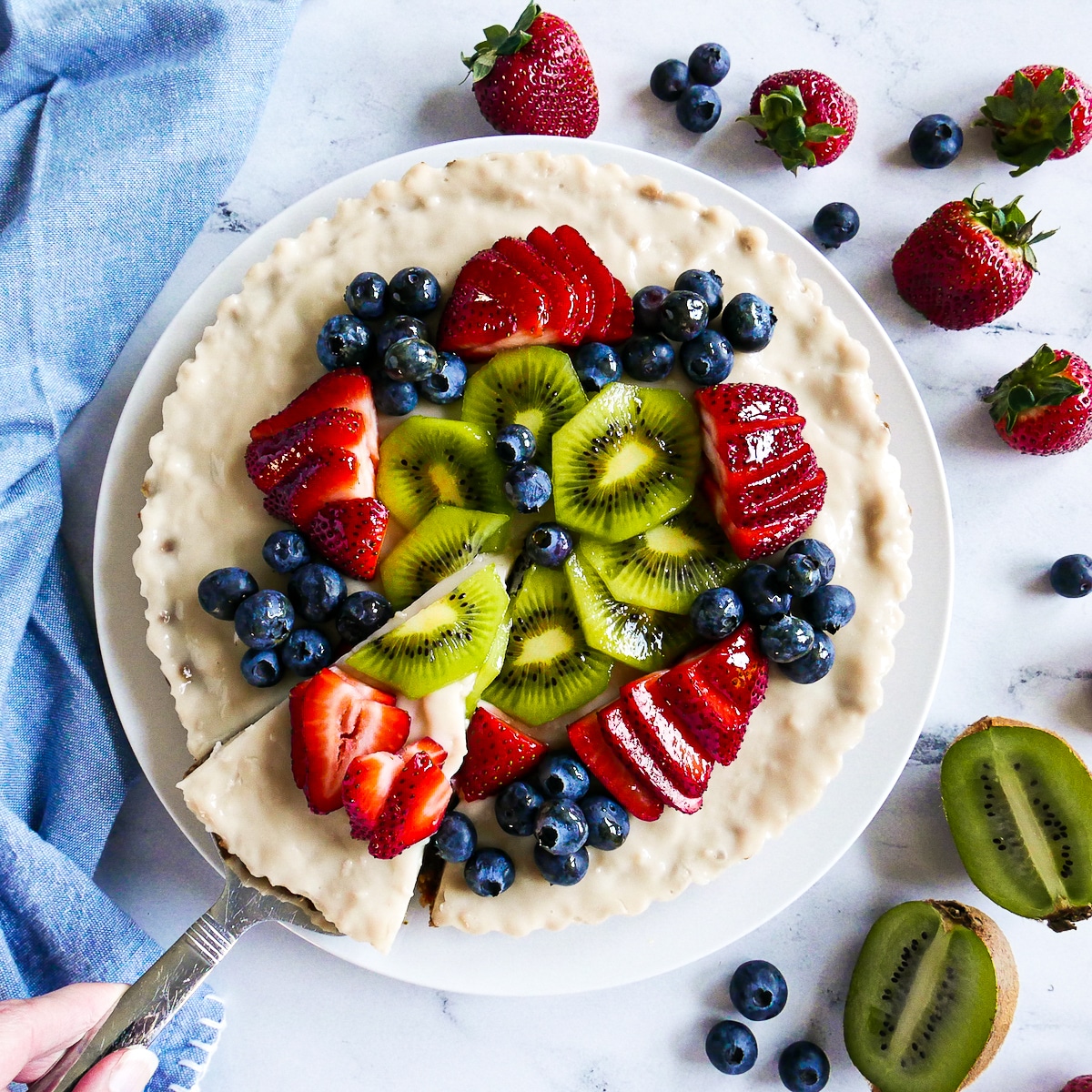 slice of dairy free fruit tart being served with a pie server.