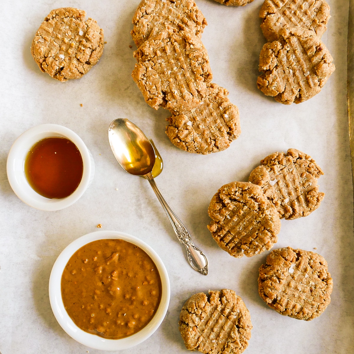 almond flour peanut butter cookies arranged on a baking sheet.