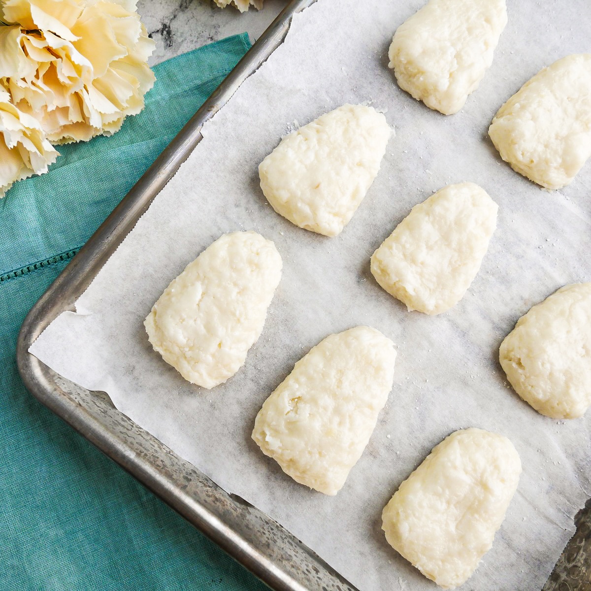 egg-shaped-filling.jpg Coconut cream filling shaped into egg shapes and arranged on a parchment lined baking sheet.