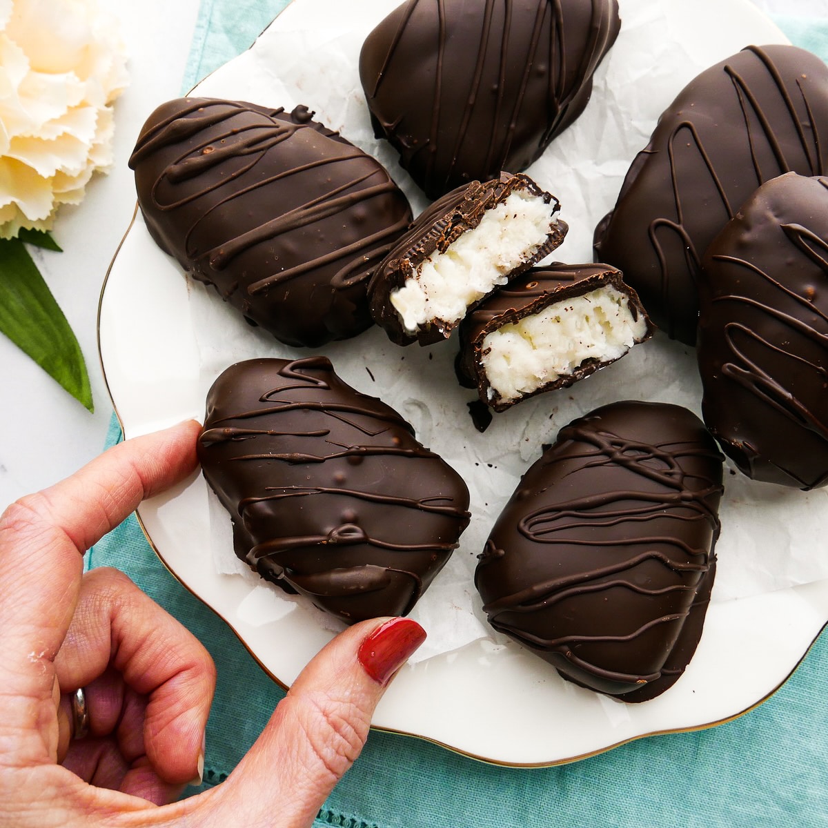 chocolate-coconut-egg.jpg Picking up a chocolate coconut egg from a platter.