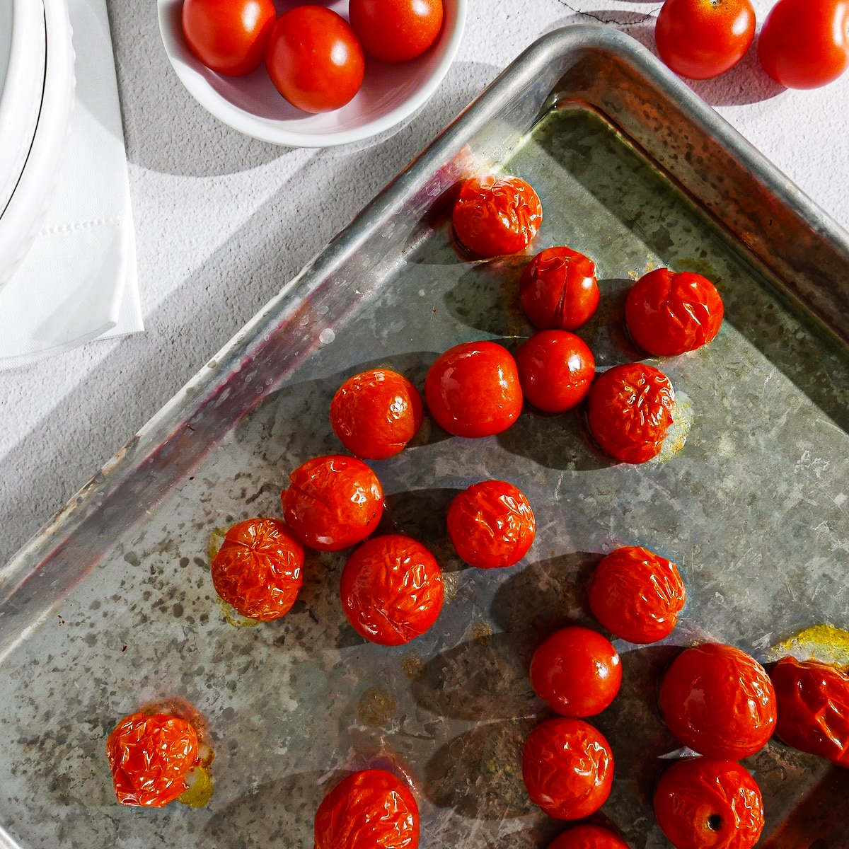 roasted tomatoes on a baking sheet.