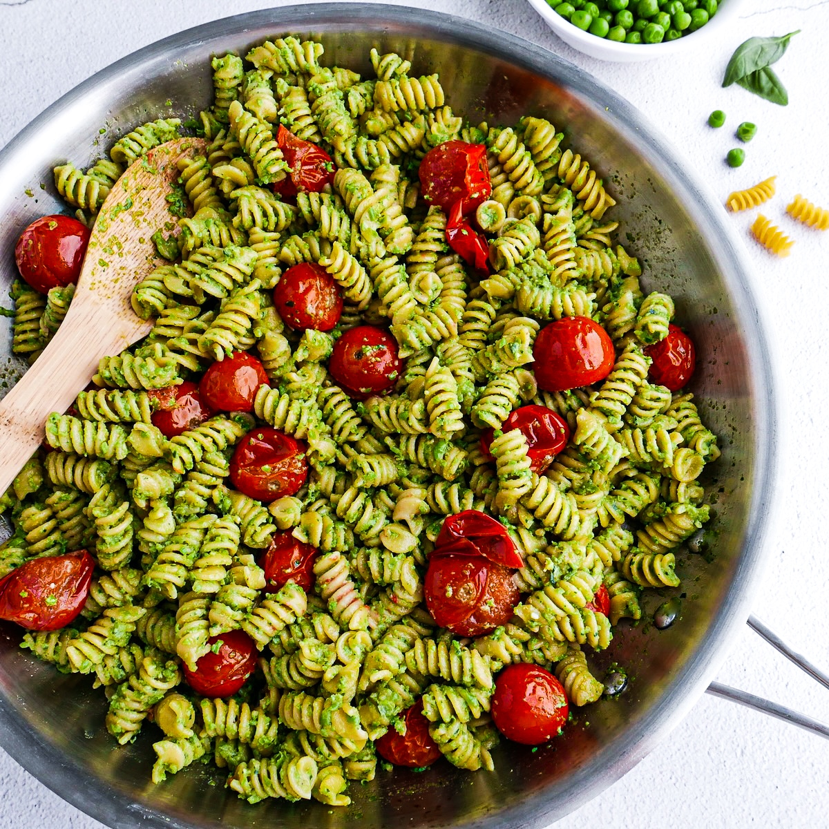 Roasted tomatoes added to pesto pasta.