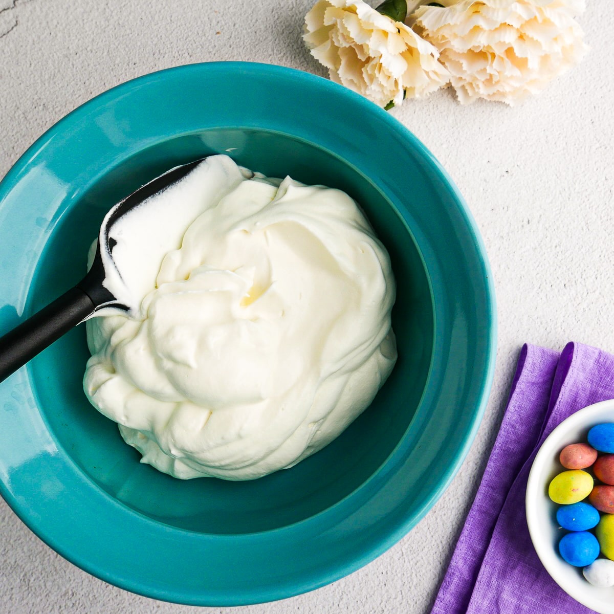 Fresh whipped cream placed into a bowl.