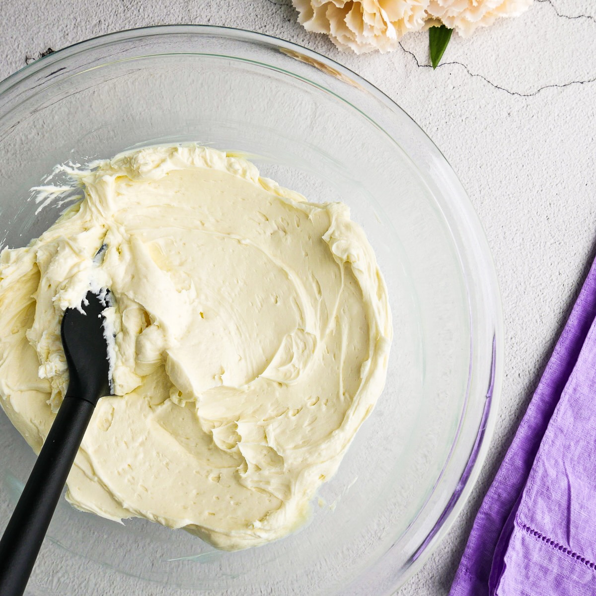 Softened cream cheese and granulated sugar mixed together in a bowl.