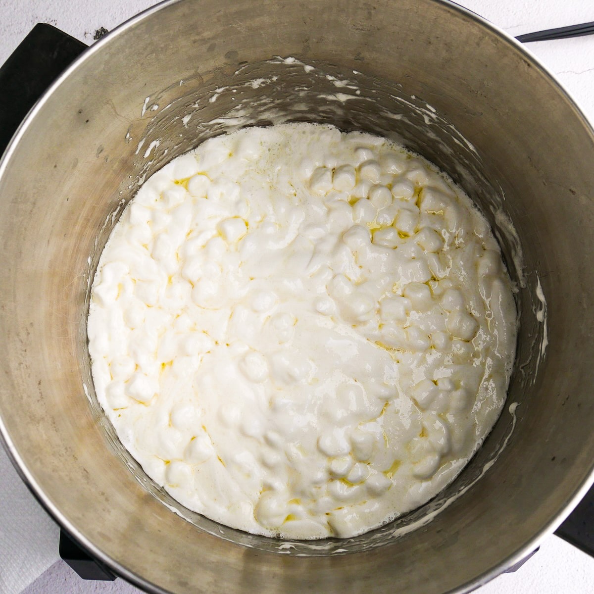 Melting marshmallows in a large saucepan.