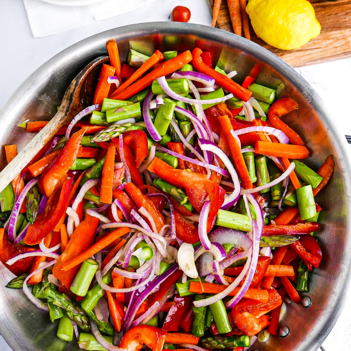 sliced-veggies-in-skillet.jpg Sliced onion, carrot, pepper, and asparagus in a large skillet.