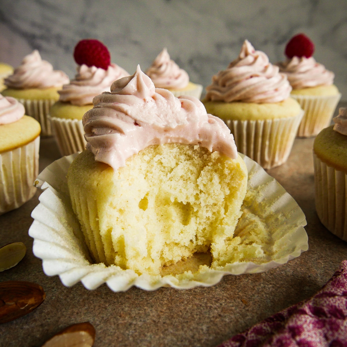 Sliced vanilla cupcake with frosting.