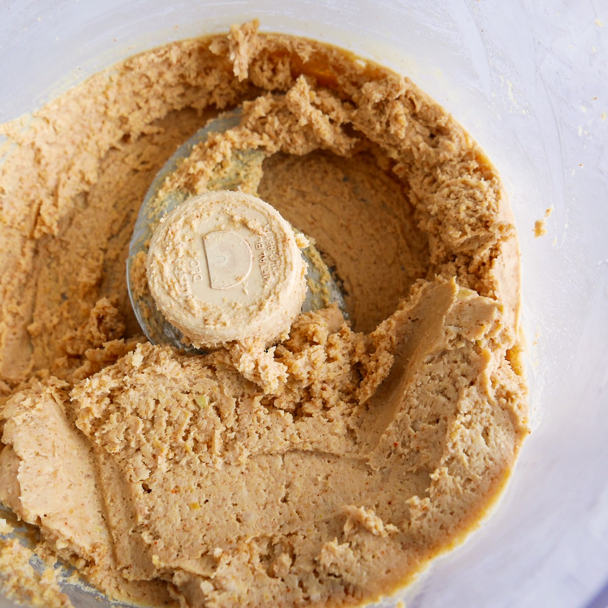 Blended hummus in a food processor.