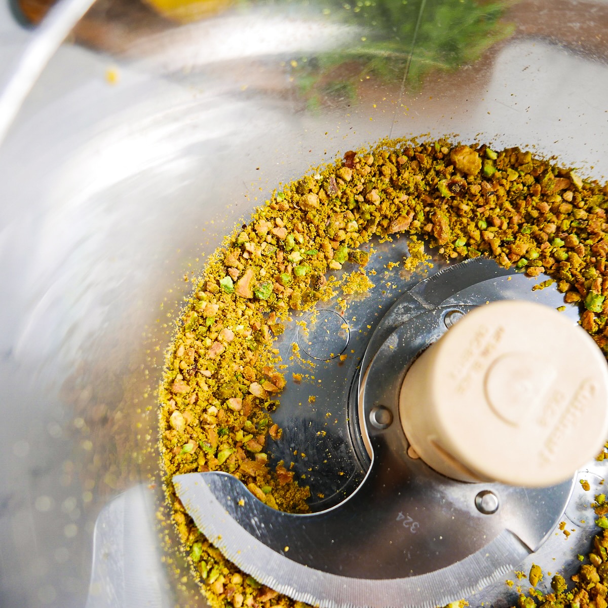 Chopped pistachios in a food processor. 