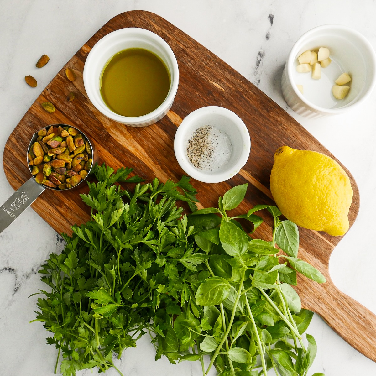 Pesto ingredients arranged on a cutting board.