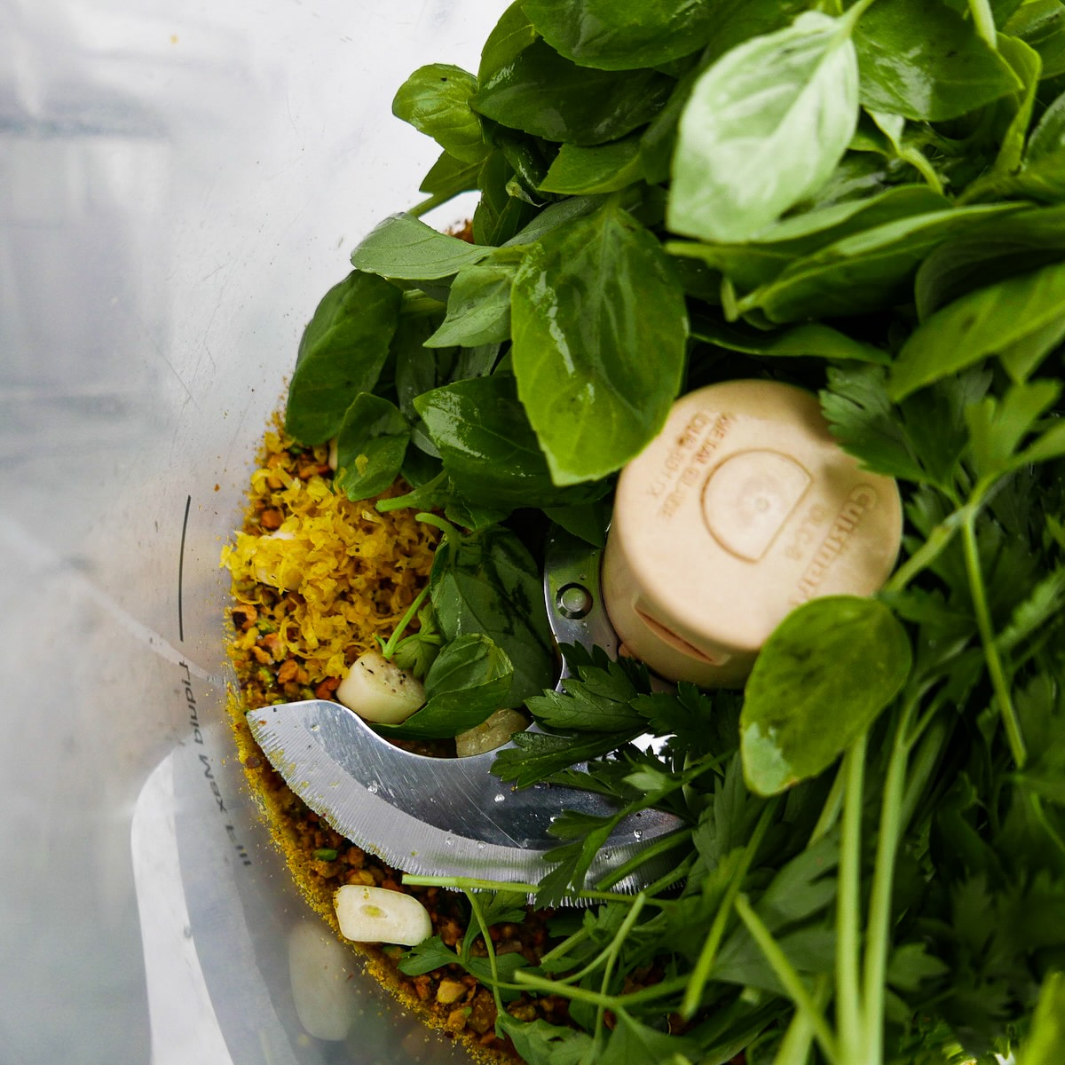 Pesto ingredients in a food processor.