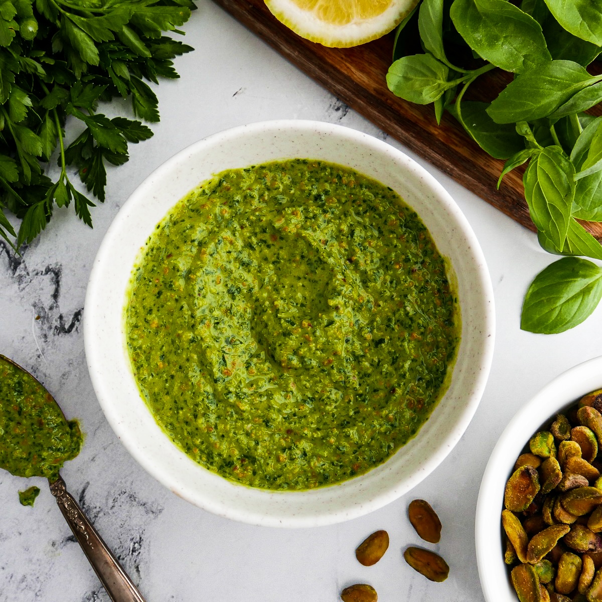 Creamy pesto served in a bowl with fresh basil.