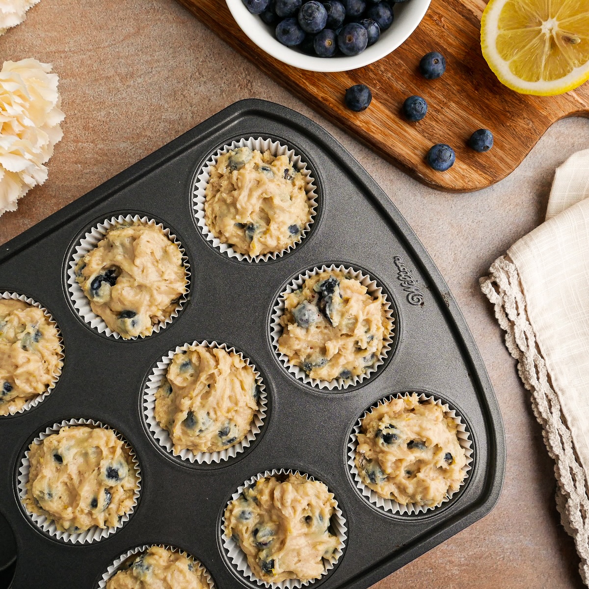 batter-in-muffin-cups.jpg Batter divided between 9 muffin cups.