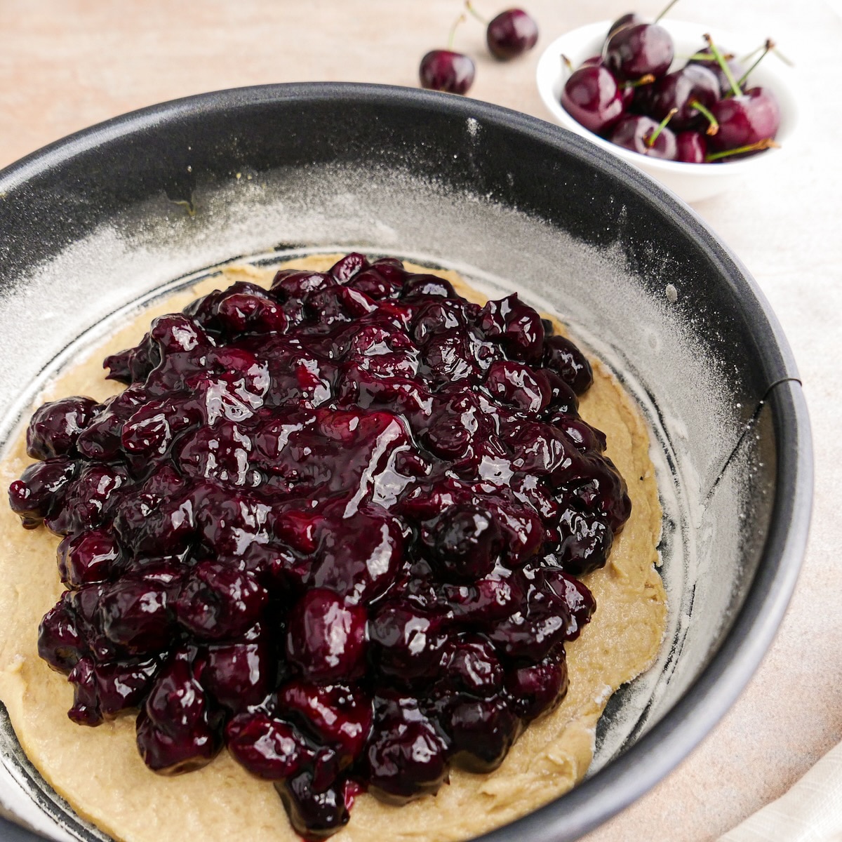 Cherry filling spread on top of cake batter.