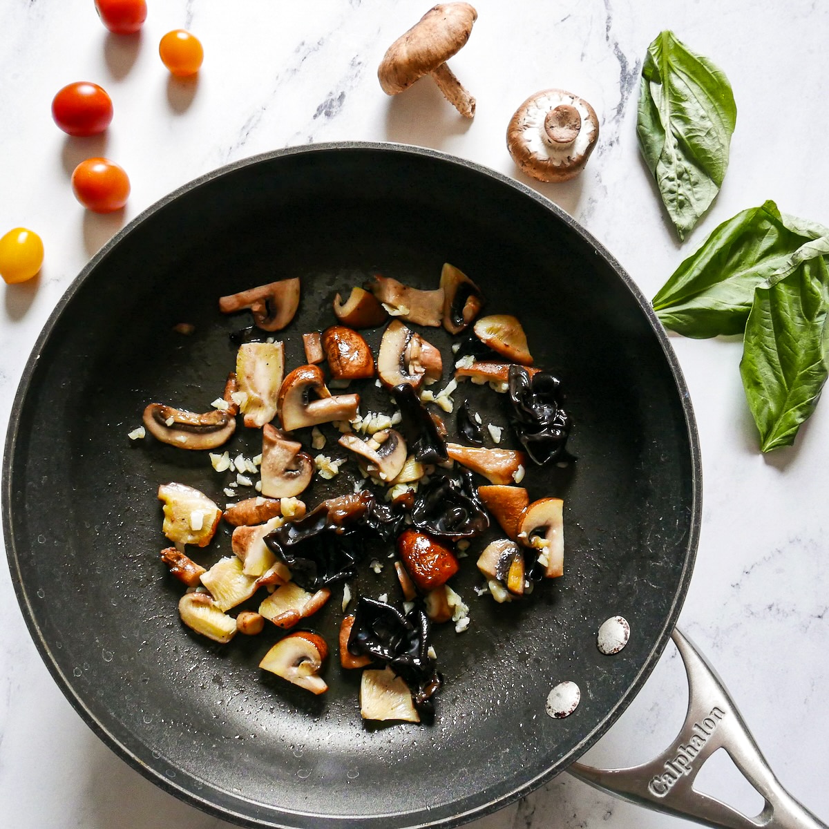 Cooked mushrooms and garlic in a skillet.