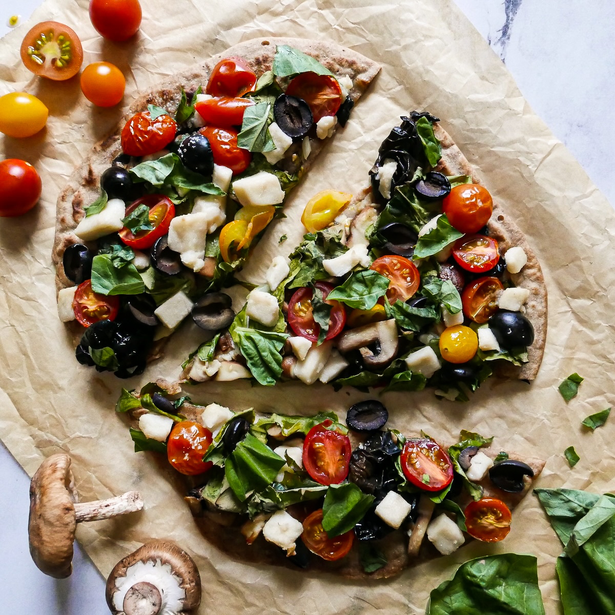 sliced-flatbread-pizza.jpg Crispy vegan flatbread pizza topped with basil.