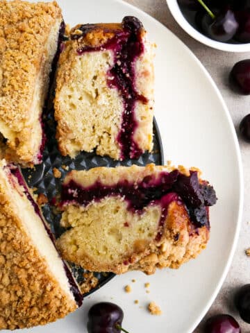 Sliced cherry coffee cake arranged on a platter.
