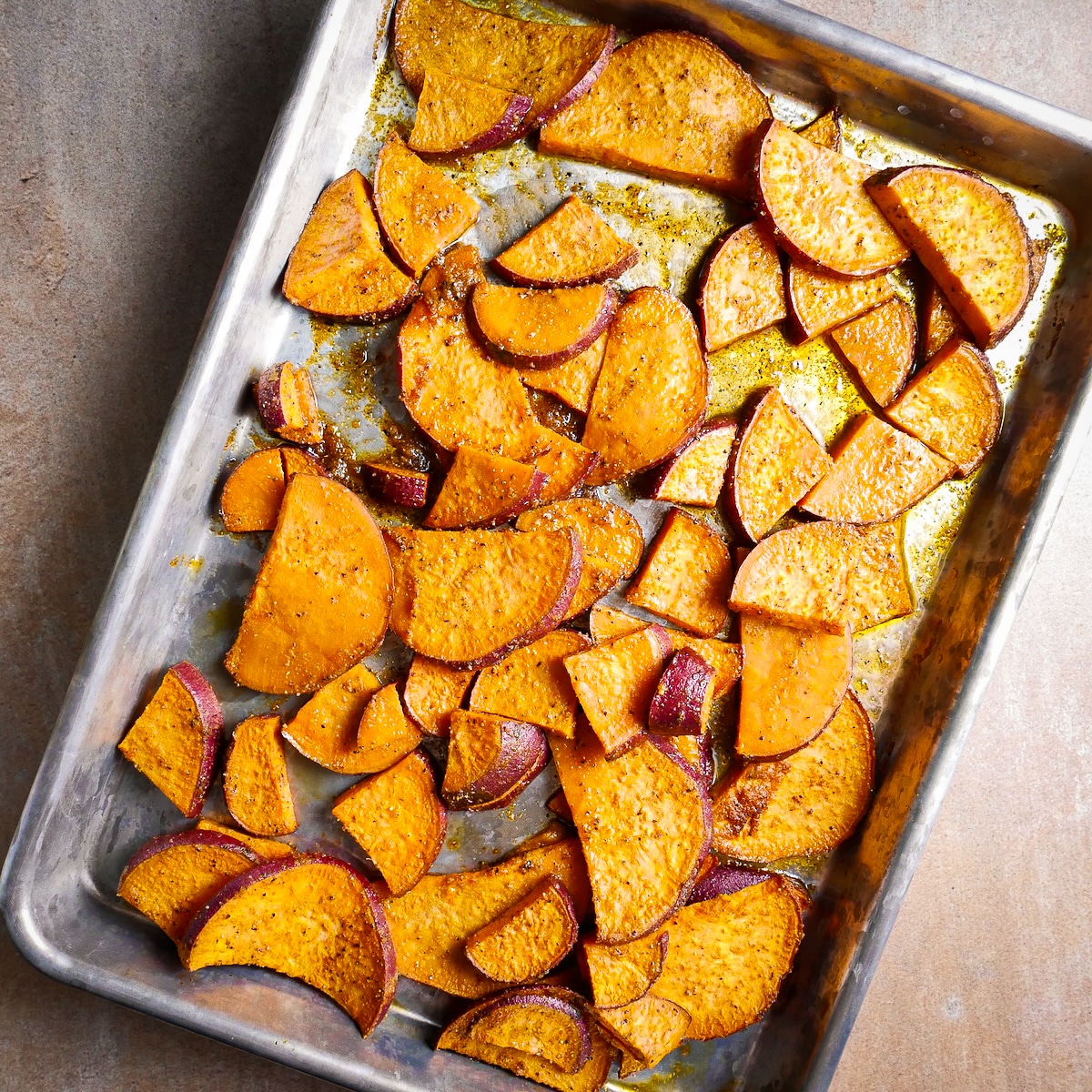 roasted-sweet-potatoes.jpg Roasted sweet potatoes arranged on a baking sheet.