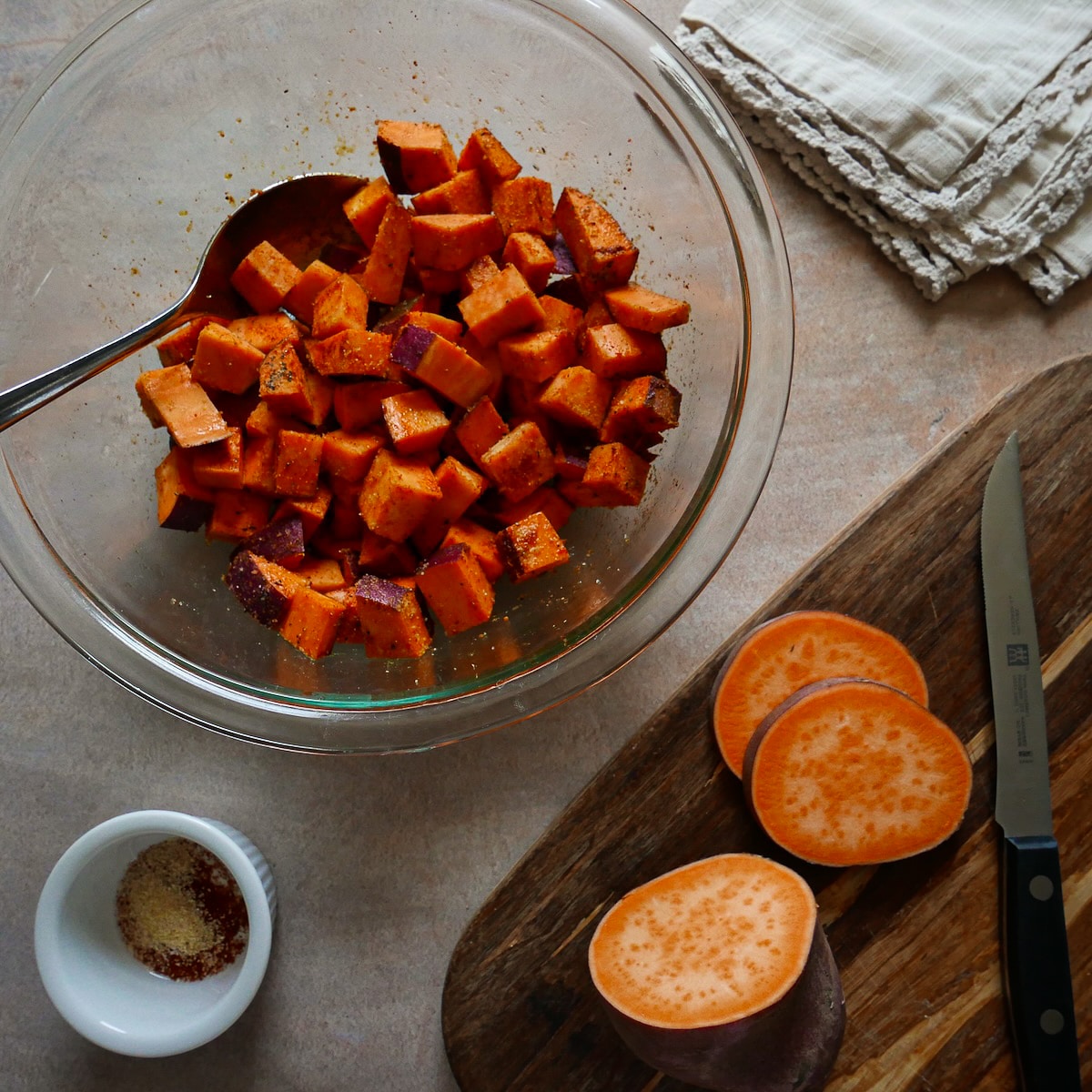 sweet-potato.jpg Sliced sweet potato tossed with spice mix in a bowl.