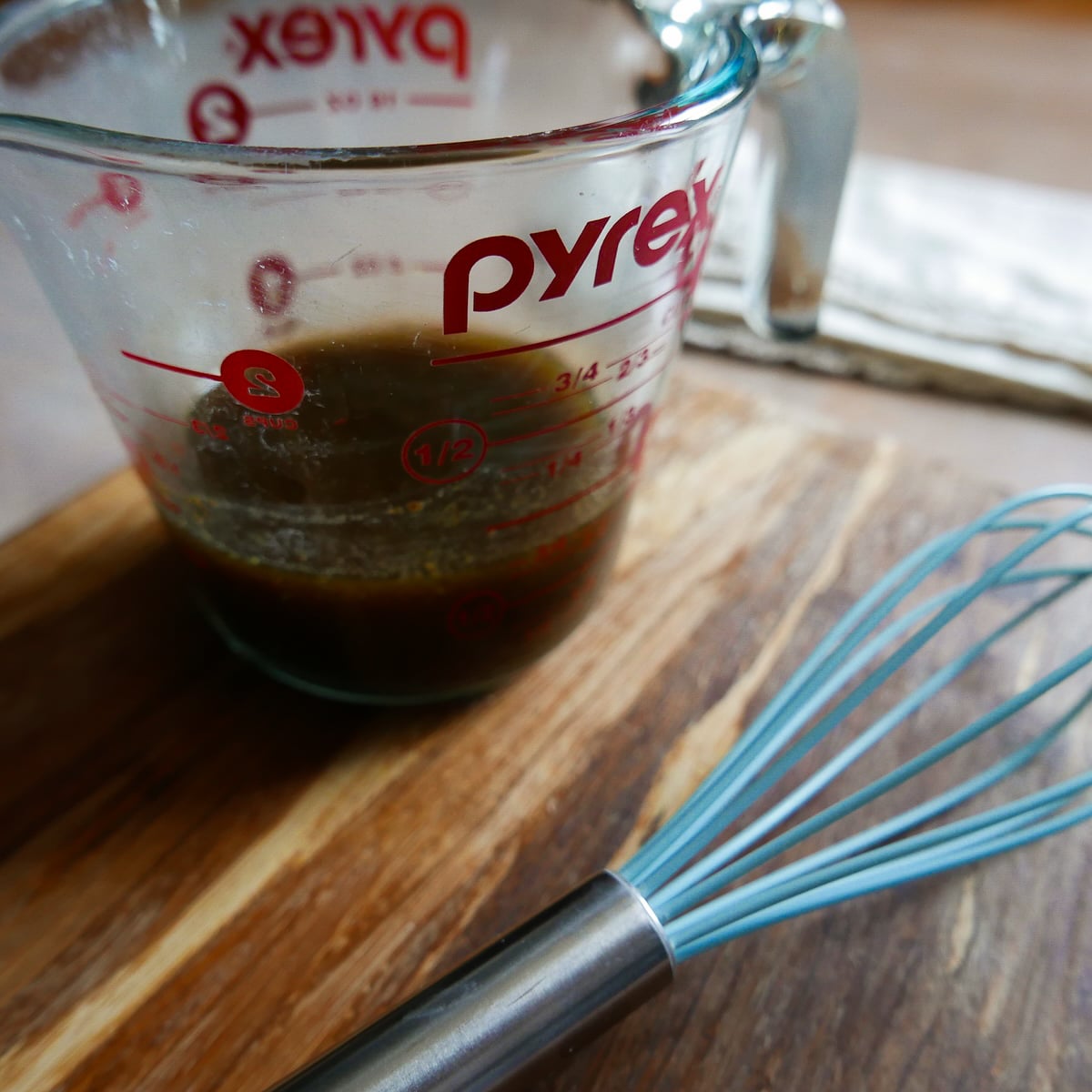 balsamic-dressing.jpg Balsamic dressing whisked in a measuring cup.