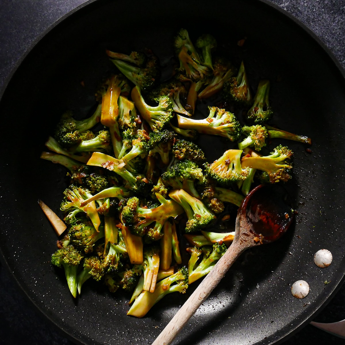 broccoli-and-sauce.jpg Stir fried broccoli mixed with garlic, ginger, and sauce in a skillet.