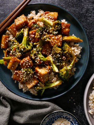Saucy broccoli & tofu stir fry served on a plate.