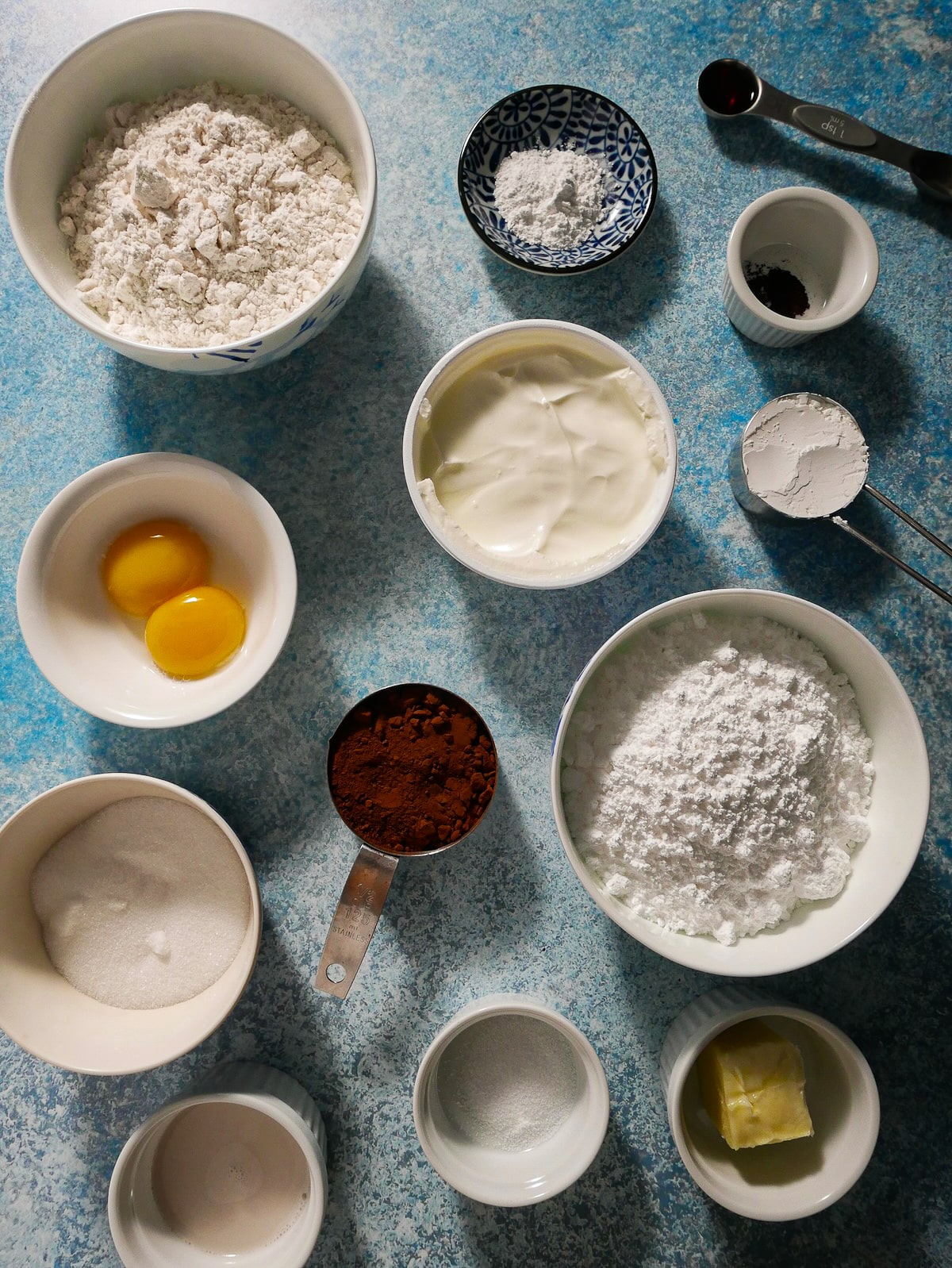 Donut ingredients arranged in bowls.