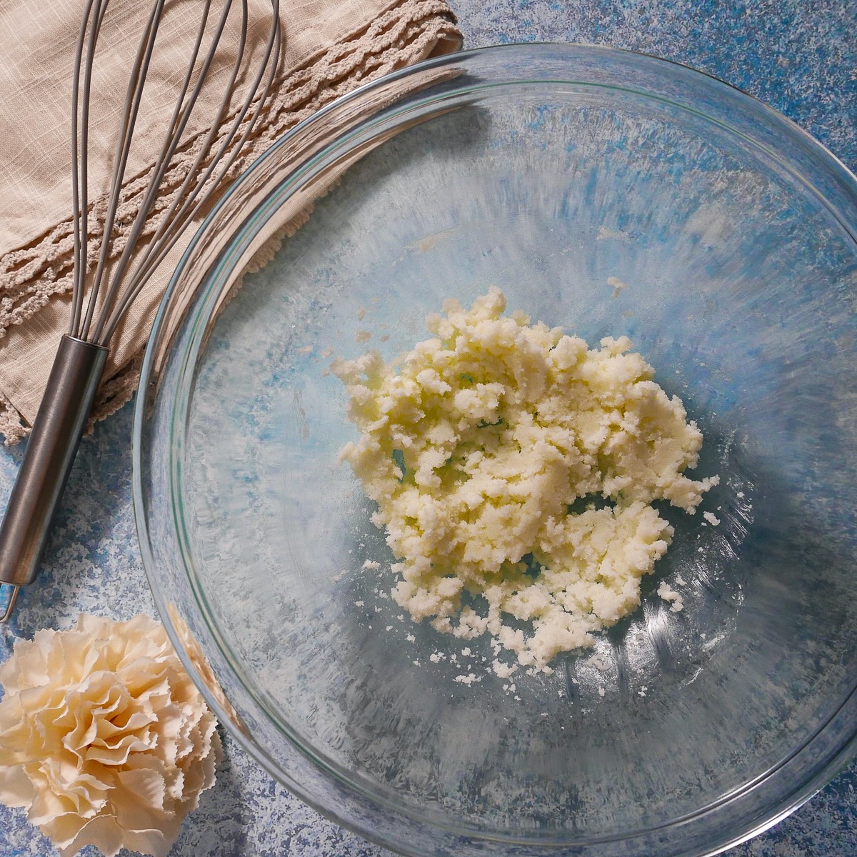 Butter and sugar creamed together in a bowl.