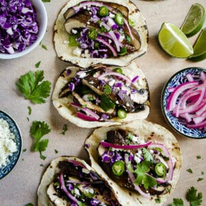 Smoky and meaty portobello mushroom tacos with fresh garnishes.
