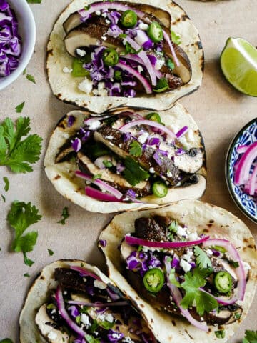 Smoky and meaty portobello mushroom tacos with fresh garnishes.