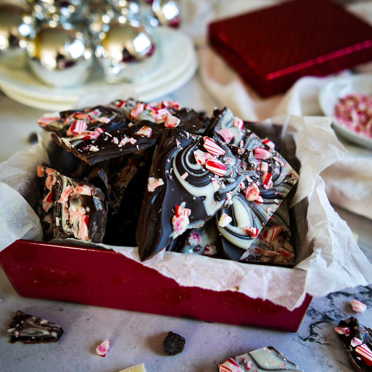 peppermint bark placed in a holiday gift box.