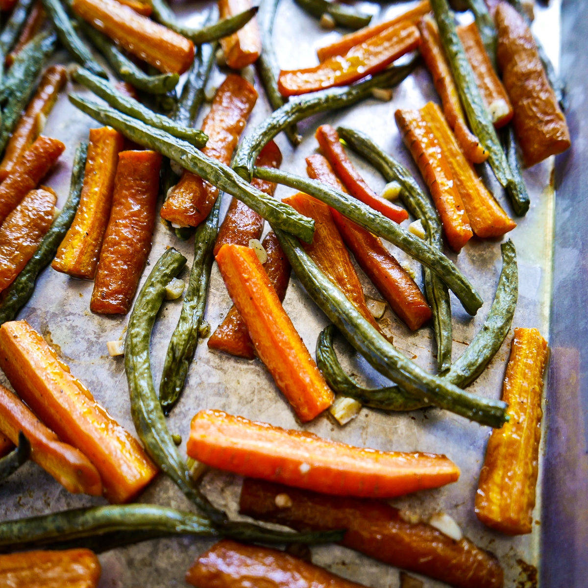 roasted-vegetables.jpg roasted vegetables on a baking sheet with a spatula.