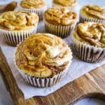 Easy pumpkin cream cheese muffins arranged on a cutting board.
