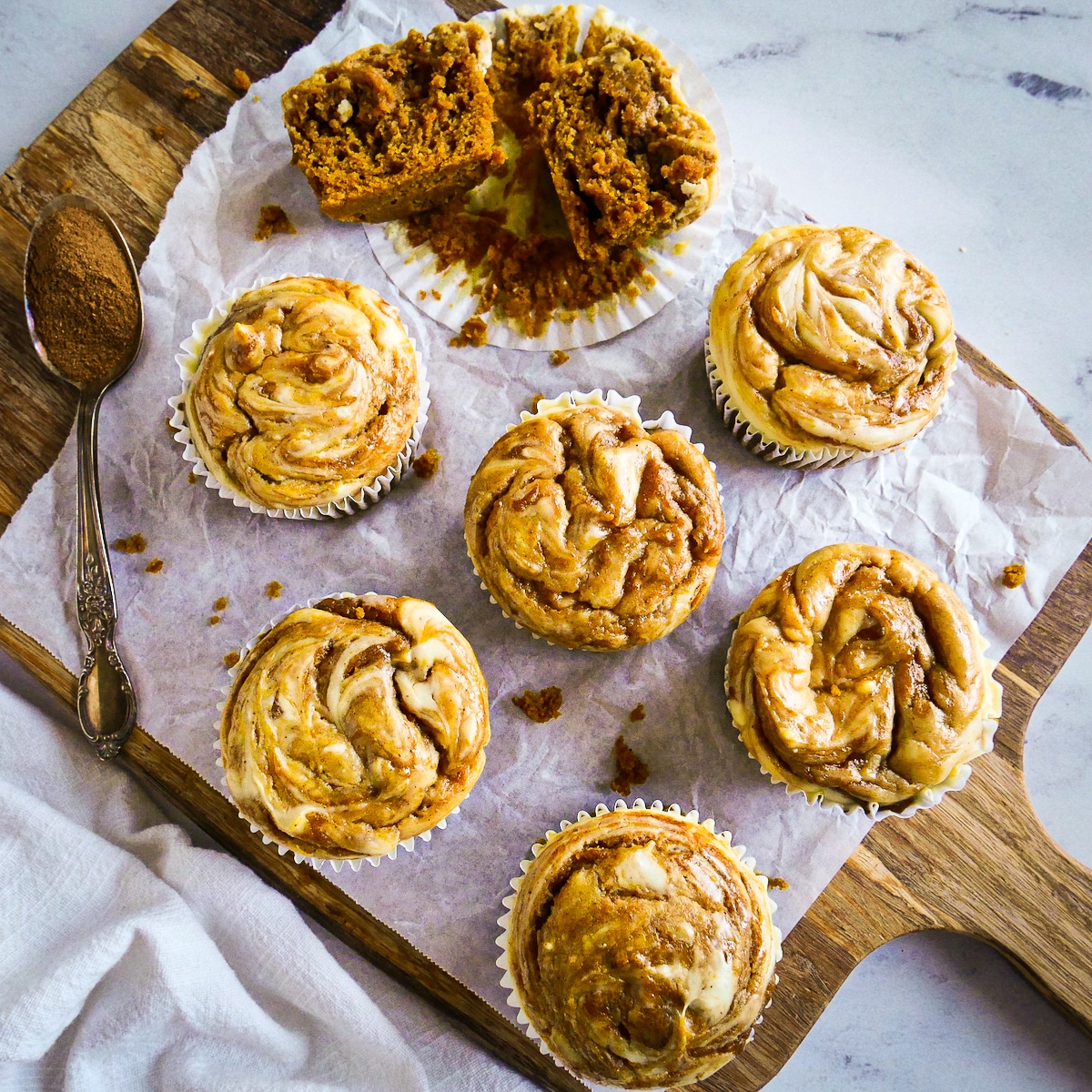 muffins-on-parchment.jpg Pumpkin muffins arranged on parchment paper with pumpkin spice.
