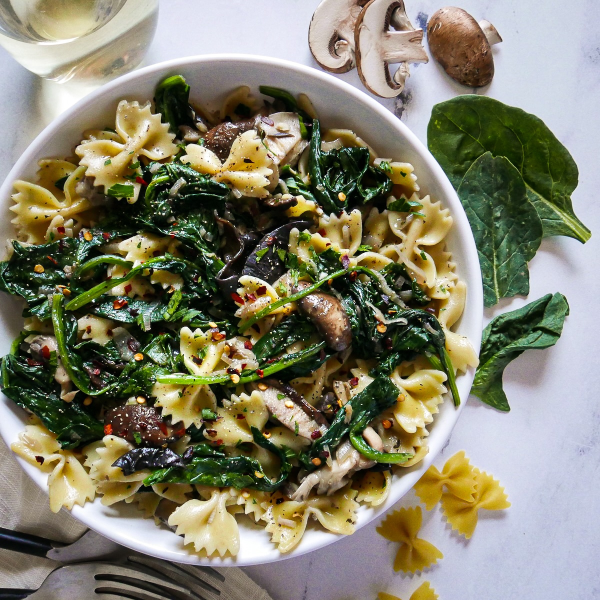 Assembled creamy pasta with spinach and mushrooms. 