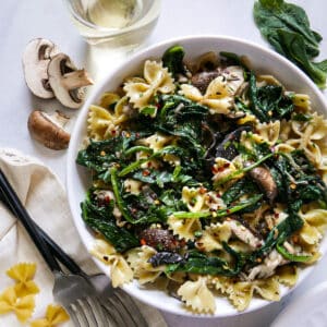 Vegetarian spinach mushroom pasta in a bowl.