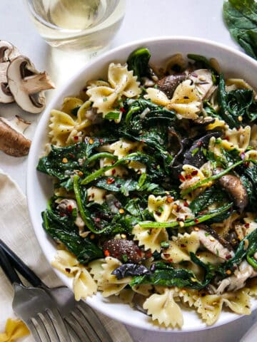 Vegetarian spinach mushroom pasta in a bowl.