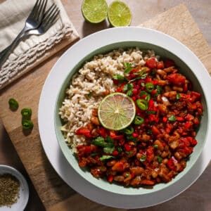 bowl of easy pinto beans and rice with two spoons and a napkin.