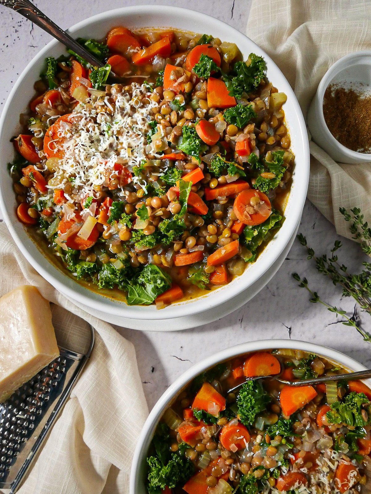 Two bowls of lentil soup with vegetables.