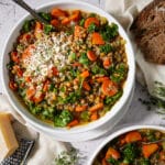 Easy vegetable lentil soup garnished with Parmesan cheese.