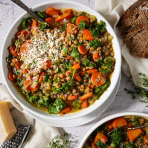Easy vegetable lentil soup garnished with Parmesan cheese.