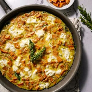Roasted sweet potato frittata in a cast iron skillet.