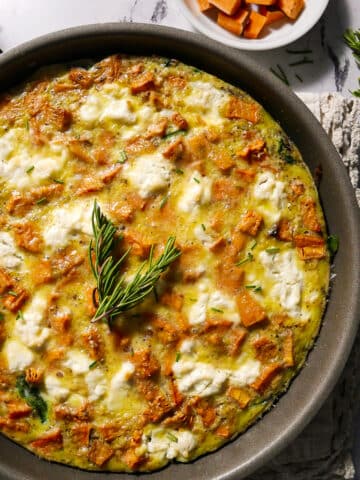 Roasted sweet potato frittata in a cast iron skillet.
