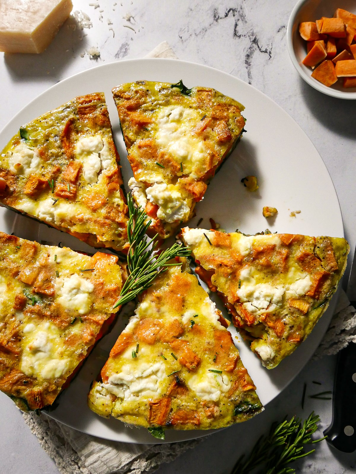 Baked vegetarian frittata with sweet potato, spinach, and shallots.