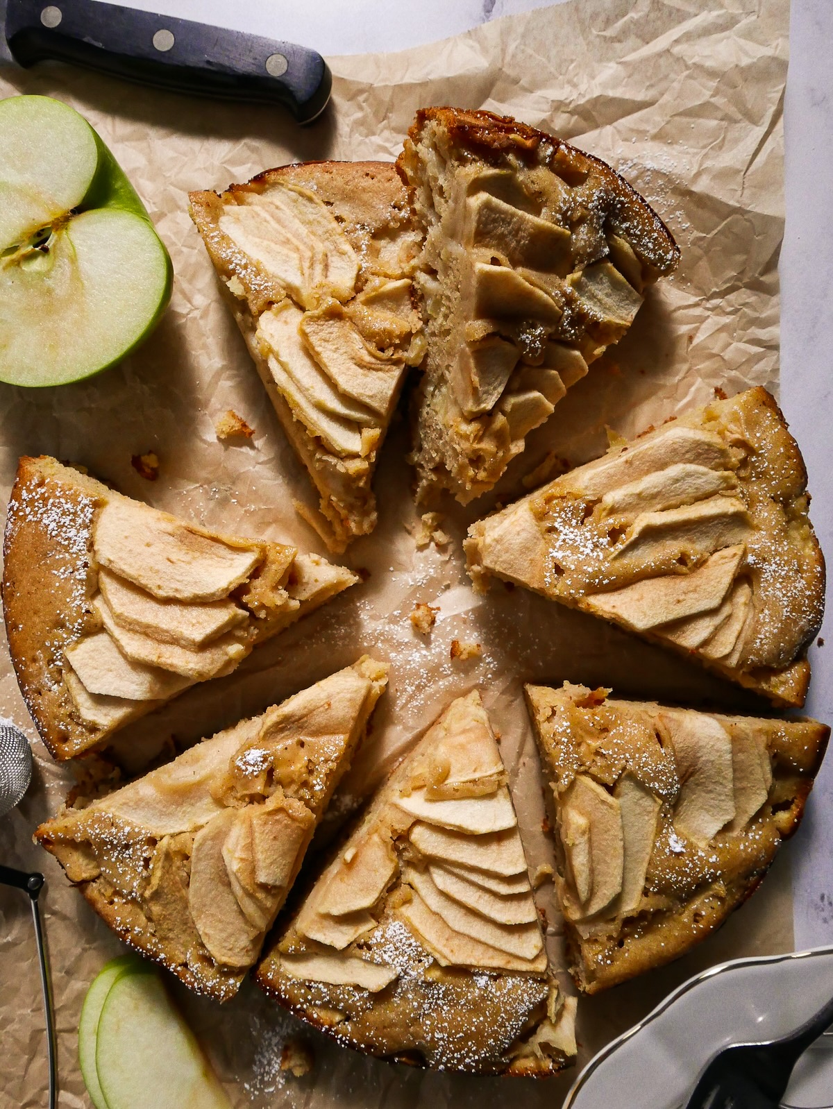 Sliced apple cake being served.