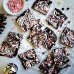 vegan peppermint bark cut into squares and arranged on parchment paper.