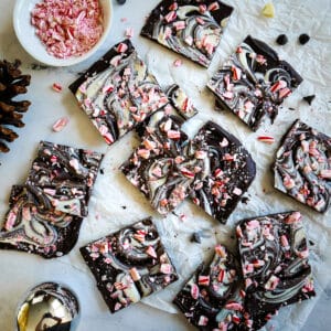 vegan peppermint bark cut into squares and arranged on parchment paper.