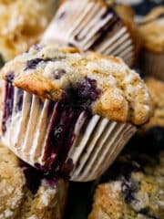 Stack of fluffy blueberry muffins on a pan.